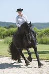 woman rides Friesian horse