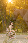 young woman with friesian mare
