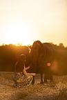 young woman with friesian mare