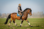 woman rides German Riding Pony