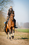 woman rides German Riding Pony