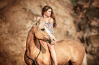 woman rides German Riding Pony