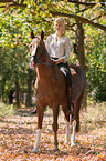woman rides German Riding Pony
