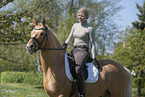woman rides German Riding Pony