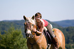 woman rides Haflinger horse