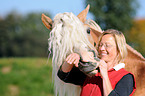 woman and haflinger stallion