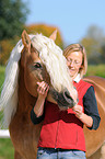 woman and haflinger stallion