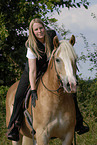 woman rides Haflinger horse