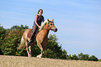 woman rides Haflinger Horse