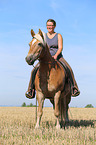 woman rides Haflinger Horse