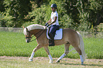 woman rides Haflinger