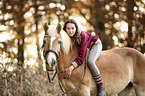 woman rides Haflinger