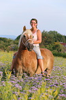 woman rides Haflinger horse