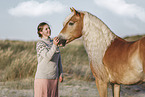woman and Haflinger horse