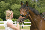woman and Hannoveraner horse