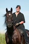 woman rides warmblood