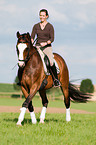 woman rides Hessian warmblood