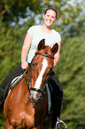 woman rides Hessian warmblood