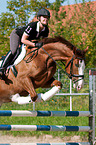 woman rides Hessian Warmblood