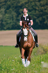 woman rides Hessian Warmblood