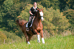woman rides Hessian Warmblood