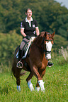 woman rides Hessian Warmblood
