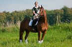 woman rides Hessian Warmblood