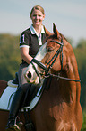 woman rides Hessian Warmblood
