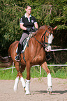 woman rides Hessian Warmblood