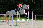 woman rides Hessian Warmblood