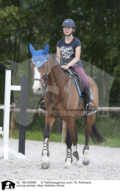 young woman rides Holstein Horse / NS-05998