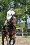 woman rides Holsteiner horse
