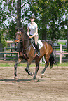 woman rides Holsteiner horse