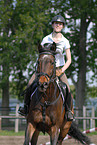 woman rides Holsteiner horse