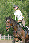 woman rides Holsteiner horse