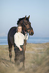 woman and holsteins horse
