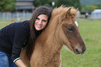 woman and Icelandic horse foal