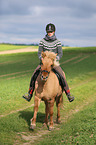 woman rides Icelandic horse