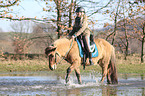 woman rides Icelandic horse