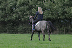 woman rides Konik