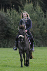 woman rides Konik