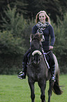 woman rides Konik