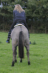 woman rides Konik
