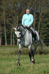 woman rides warmblood