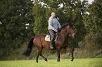 man rides Mecklenburg Warmblood