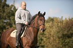 man rides Mecklenburg Warmblood