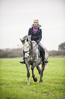 woman rides Oldenburg Horse
