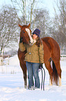 woman with Paint Horse in snow