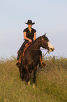 woman rides Paint Horse