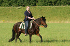 woman rides pony